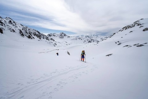 Ski tourer in mountain landscape with snow, ascent to Grialetsch Scharte, Bündner Haute Route,