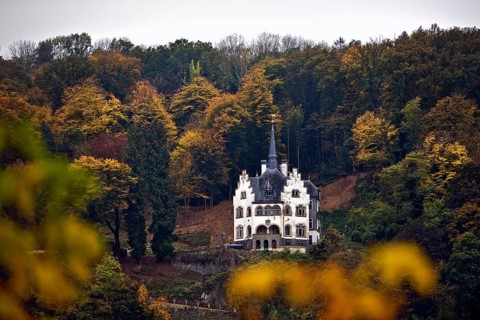 Listed, late historicist villa with stepped gable above the banks of the Rhine in autumn, Remagen,