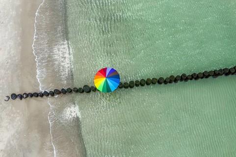 People with colorful umbrella on a groyne, beach of Baltic sea, aerial view, Mecklenburg-Western