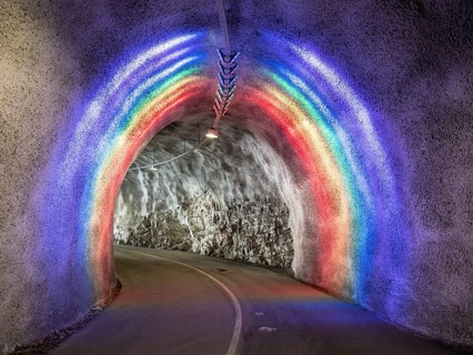 Colorful illuminated tunnel for bicycles and pedestrians leads up to Hardanger suspension bridge,