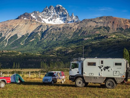 Tents on campsite in village Villa Cerro Castillo, expedition truck, mountain Cerro Castillo in the