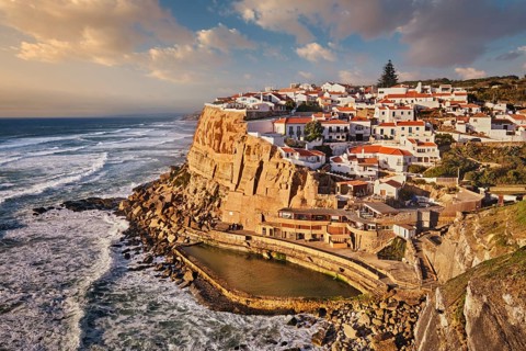Scenic view of the seaside Azenhas do Mar fishing village on cliff on Atlantic ocean coast,