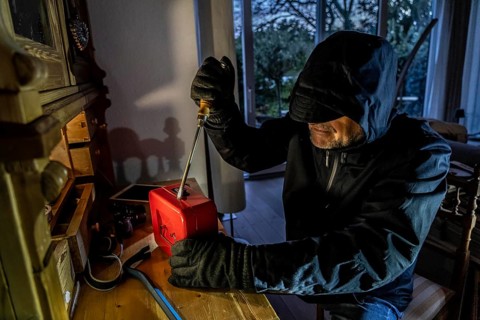 Symbolic image of a burglary, perpetrator has broken into a flat from the garden side and is