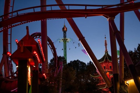 Roller coaster, chain carousel and pagoda at night, Tivoli Amusement and Recreation Park,