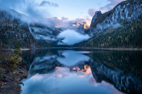 The Vordere Gosausee lake in autumn with a view of the Dachstein mountain range. The Gosaukamm on