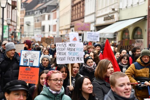 Heidelberg, Germany - February 12th 2025: Crowd of people with signs at protest against far-right