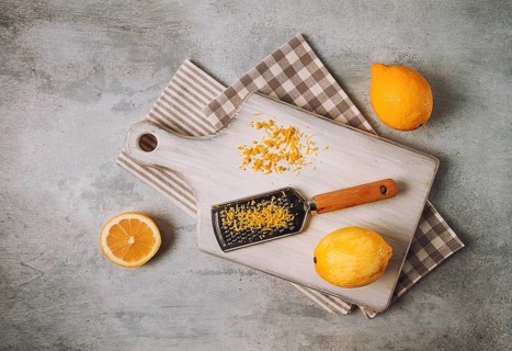 Grated lemon zest, on a cutting board, with a grater, top view, no people