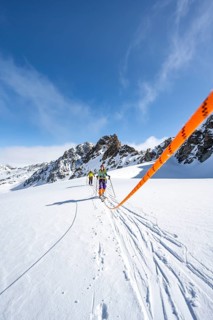 Ski tourer with rope, rope team on the Vadret da Porchabella glacier on the ascent to the summit of