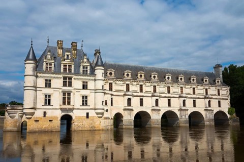 Historic castle with towers and water reflection under a cloudy sky, Chenonceau Castle, Château de
