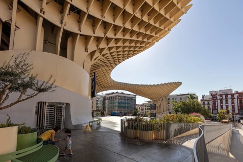 Metropol Parasol with people in the foreground and bright sunshine in the city, Seville