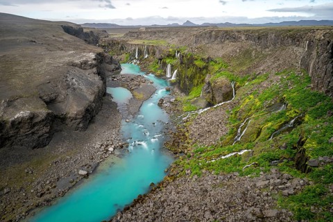 Waterfalls and a turquoise blue river flowing through a canyon, Sigöldugljúfur, long exposure,