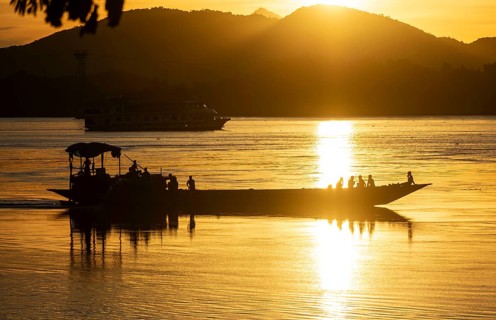 Boats in the Brahmaputra river, during sunset in Guwahati, Assam, India on 1 August 2023