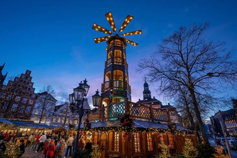 Christmas market with large Christmas pyramid at dusk, behind the historic town hall, Lüneburg,