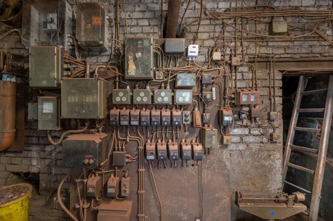 Wall with switches and fuses in the bronze powder production building, founded in 1900, metal