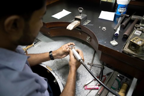 Sri Lankan man cutting a sapphire ring, gemstone cutting workshop in Kandy, Central Province, Sri