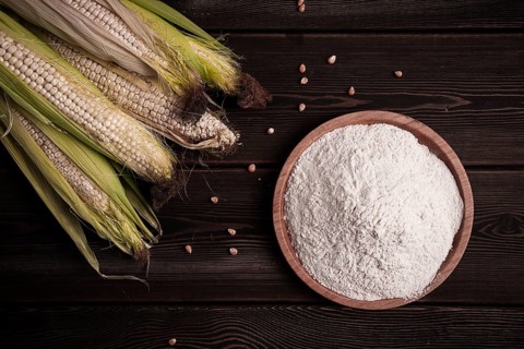 Corn cobs, corn flour, on a wooden table, top view, close-up, rustic, selective focus, dairy corn
