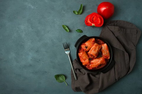 Stuffed cabbage rolls in tomato sauce stuffed cabbage leaves, minced meat with rice, on a dark