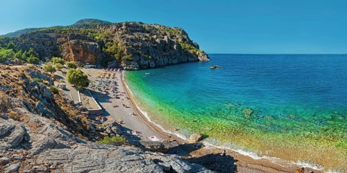 Panoramic view of Ahata Beach with clear, turquoise-coloured sea and steep cliffs, Ahata Beach,