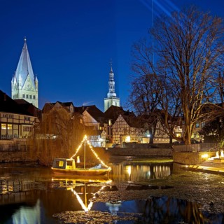 Large pond, St. Patrokli Cathedral and St. Peter's Church in the evening during winter sunshine,