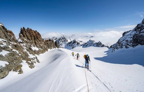 Ski tourer with rope, rope team on the Vadret da Porchabella glacier on the ascent to the summit of