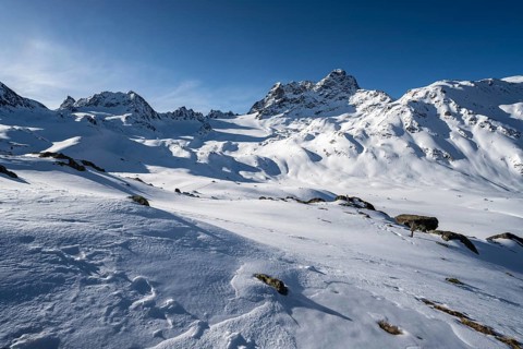 Mountain peak Piz Kesch with snow, view at the Kesch hut in winter, Grisons Haute Route, Albula