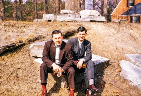 Two elegantly dressed men sitting outside and looking into the camera, USA around 1953