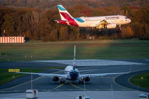 Eurowings Airbus A319-132, landing at Cologne-Bonn Airport, Sunexpress Boeing 737 waiting for