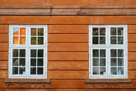 Windows with white frames, rust-red house, Frederiksholms Canal, Copenhagen, Denmark, Europe