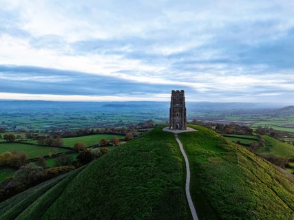 Sunrise over Glastonbury Tor from a drone at autumn, Glastonbury, Somerset, England, United