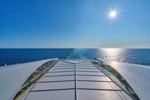 View from the ship's deck, Mein Schiff 6, of the vast sea under bright sunshine and blue skies,
