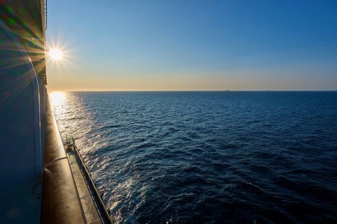 View from cruise ship, Mein Schiff 6, onto the wide sea at sunrise, under a clear blue sky, autumn,