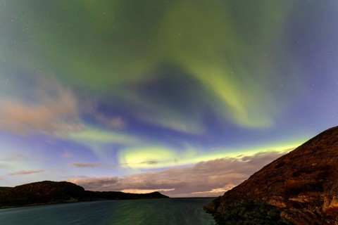 Northern Lights, (Aurora borealis) at a fjord in the Barents Sea near Bugoynes, September 2024,
