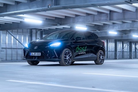 Black car with front lights switched on in car park, e-car sharing, Deer Mobility, MG4, Calw,