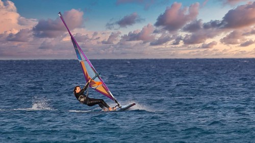 Sky exchanged, colourful windsurfer on the sea with vivid sky, windsurfer, Meltemi windsurfing