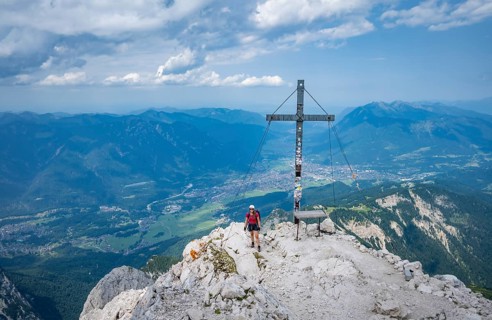 Hiker on the summit of the Alpspitze, Wetterstein range, Bavaria, Germany, Europe