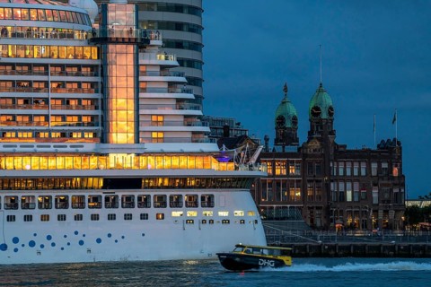 Cruise ship Aida Prima at the Cruise Terminal of Rotterdam, Kop van Zuid, skyscrapers at the