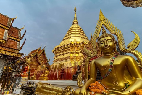 Buddha statue and Golden Chedi of the Buddhist temple complex Wat Phra That Doi Suthep, landmark of