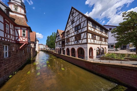 River Mümling, historic half-timbered houses, trees, blue sky with cumulus clouds, Erbach,