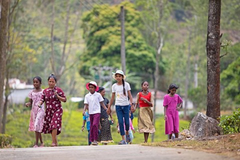Sri Lankan woman and children go for a lunch break on a tea plantation, Ramboda, Nuwara Eliya,
