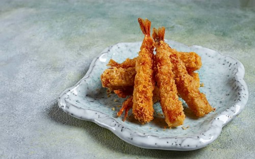 Fried shrimp, peeled in tempura, soy sauce, close-up