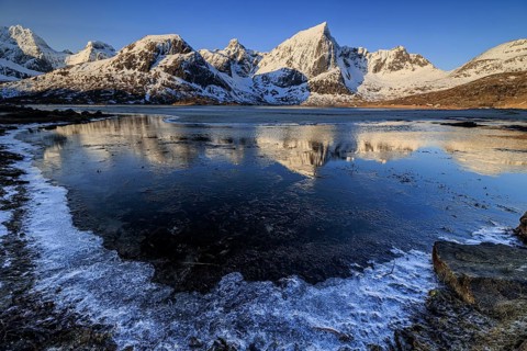 Sunrise, morning light, steep mountains and fjord, ice, winter, Flakstadoya, Lofoten, Norway,