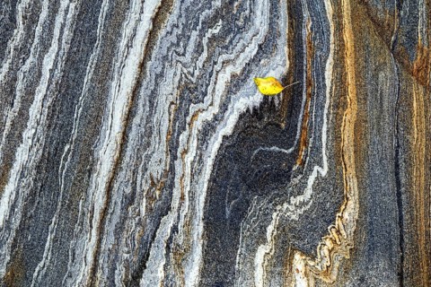 Rock structures with autumn leaves in the Verzasca River, near Lavertezzo, Canton Ticino,