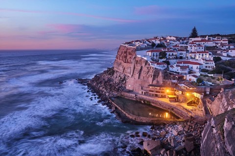Scenic view of the seaside Azenhas do Mar fishing village on cliff on Atlantic ocean coast,