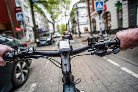 Cycling in the city, inner-city street, cycle lane, bicycles have priority, two-lane traffic with