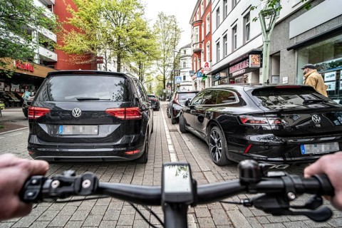 Cycling in the city, inner-city street, cycle lane, bicycles have priority, two-lane traffic with