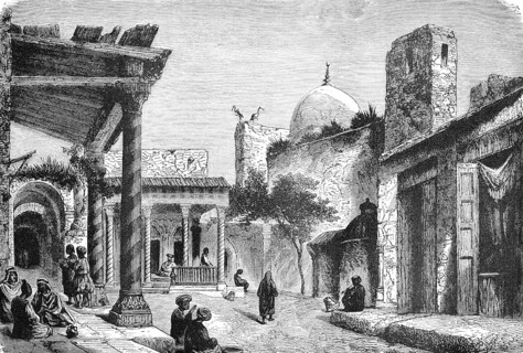 In the bazaar of a Turkish old town, street with shops, dome of a mosque, shady corridors, people,