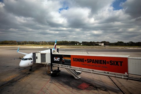 Aircraft Airbus A320 of the airline Eurowings GmbH at passenger boarding bridge or finger,