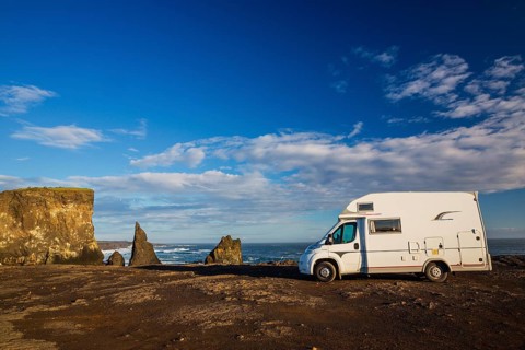 Motorhome parking on the shoreline, south of Sandvik with crashing waves. Rough nature