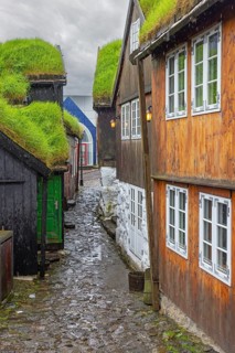 Cobbled alley and traditional wooden houses with turf roofs at Tinganes, the old town of Tórshavn,