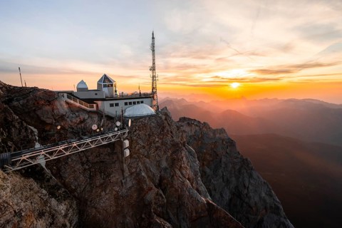 Mountain station of the Tyrolean Zugspitze railway at the summit of the Zugspitze, at sunset,